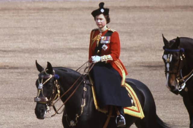 The Queen in 1969 riding her horse Burmese to inspect the 1st Battalion, Scots Guards, during the Trooping the Colour ceremony at Horse Guards Parade. PA Archive/PA Wire