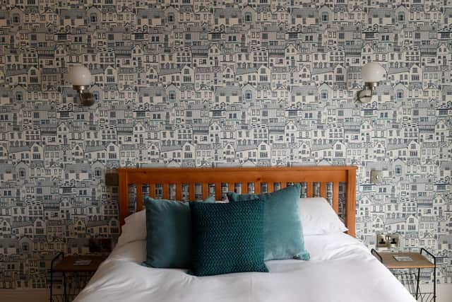 Jess's own design and best-selling Coastal wallpaper in the apartment's huge bedroom