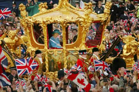 Queen Elizabeth and Prince Philip ride in the Golden State Carriage at the head of a parade from Buckingham Palace to St Paul's Cathedral celebrating the Queen's Golden Jubilee June 4, 2002 along The Mall in London.  (Photo by Sion Touhig/Getty Images)