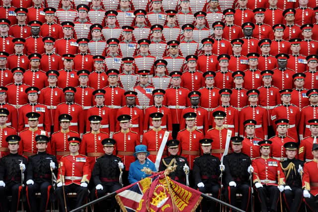 LONDON - MAY 11:  Queen Elizabeth II poses for an official photograph with the Grenadier Guards in Wellington Barracks after presenting the regiment with their new colours on May 11, 2010 in London, England. The Queen paid tribute to the families of Grenadier Guardsmen killed while fighting in Afghanistan and comrades wounded in action as she presented the regiment with new colours today. (Photo by Anthony Devlin/WPA Pool/Getty Images)