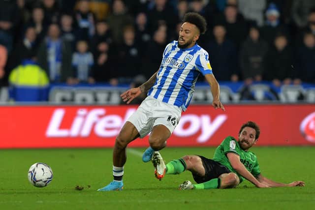 ON THE RISE: Huddersfield Town's Sorba Thomas battles with Stoke City's Joe Allen in January this year 
Picture: Bruce Rollinson