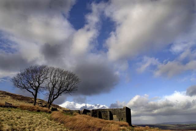 Top Withens high on the Pennine Moors above Haworth, the ruins have long been associated with the Bronte's as the home of the Earnshaw's in Emily Bronte's novel 'Wuthering Heights'. Writer: Bruce Rollinson
