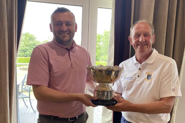 WORTHY WINNER: Wetherby Golf Club’s assistant general manager Chris Lander, left, receives the John Keightley Trophy from Horsforth’s Simon Lax, Leeds Union’s president elect. Picture: Leeds & District Union.