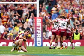 Huddersfield Giants' Joe Greenwood reacts to his team's Challenge Cup Final defeat as Wigan Warriors player celebrate at the Tottenham Hotspur Stadium Picture: Mike Egerton/PA