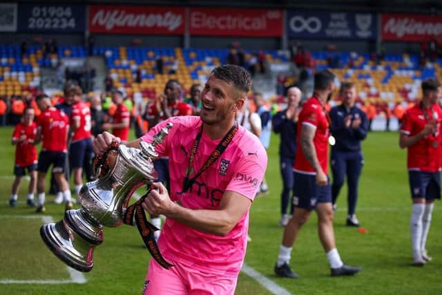 PROMOTION WINNER: Peter Jameson celebrates with the trophy after York City won their promotion final