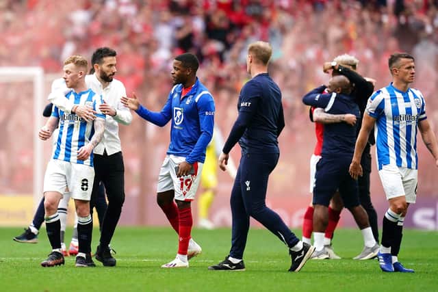 Huddersfield Town manager Carlos Corberan (second left) consoles his players after defeat to Nottingham Forest in the Sky Bet Championship play-off final at Wembley Picture: John Walton/PA