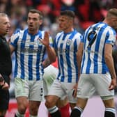 Huddersfield Town's Harry Toffolo remonstrates with referee Jon Moss after being booked for diving during the Championship Play-Off Final against Nottingham Forest at Wembley Picture: Mike Hewitt/Getty Images