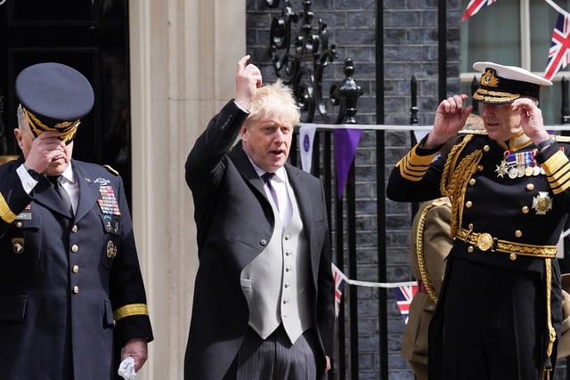 Prime Minister Boris Johnson poses for a photograph with military personnel outside 10 Downing Street, London.