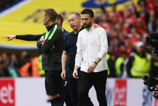 JOB WELL DONE: Huddersfield Towen head coach Carlos Corberan - pictured at Wembley last Sunday with Nottingham Forest boss Steve Cooper consoling him at the final whistle. Picture: Mike Hewitt/Getty Images