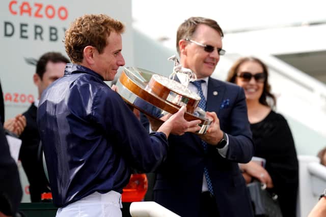 Winning team: Jockey Ryan Moore (left) and trainer Aidan O'Brien celebrate with the trophy after Tuesday wins the Cazoo Oaks. Picture: John Walton/PA Wire.