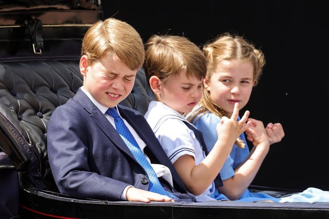 Prince George, Prince Louis and Princess Charlotte travel in a horse-drawn carriage during the Queen's Birthday Parade.