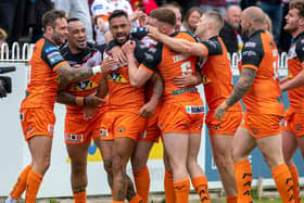 Kenny Edwards, third from left, celebrates his first try which put Tigers 12-0 up against Wigan. Picture by Bruce Rollinson.