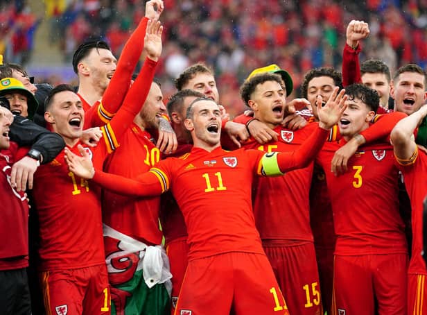 Wales' Gareth Bale (centre) celebrates with team-mates and staff after qualifying for the Qatar World Cup following victory in the FIFA World Cup 2022 Qualifier play-off final match at Cardiff City Stadium over Ukraine. Picture: David Davies/PA Wire.