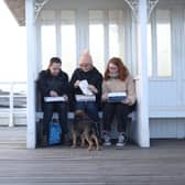 Library image of people eating fish and chips on Cromer Pier in North Norfolk