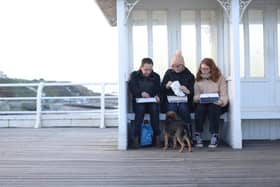 Library image of people eating fish and chips on Cromer Pier in North Norfolk