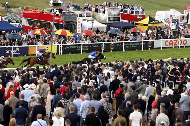 Winning performance: Racegoers watch as Tees Spirit ridden by jockey Barry McHugh wins the Simpex Express 'Dash' Handicap on Derby Day at Epsom. Picture: Steven Paston/PA Wire
