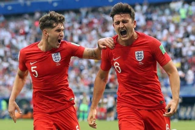 Harry Maguire celebrates with team-mate John Stones after scoring for England against Sweden. Picture: PA