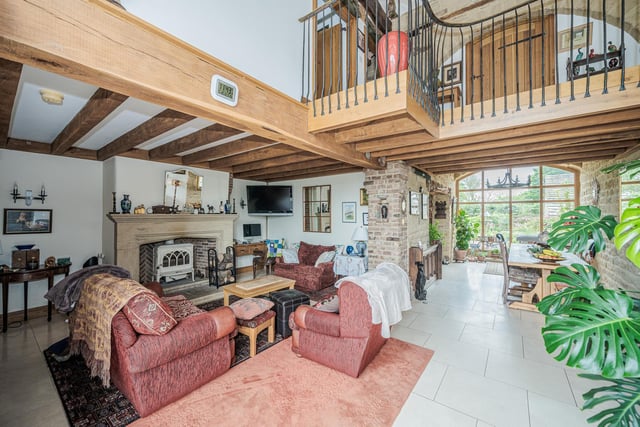 The snug has the original barn window with double doors leading out to rear garden, a stone fireplace housing a Jotul wood burning stove, exposed beams, exposed stone and brickwork, marble flooring and inset floor spotlights.
