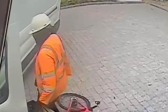 The man police want to speak to was seen loading items into a van while wearing a hi-vis jacket