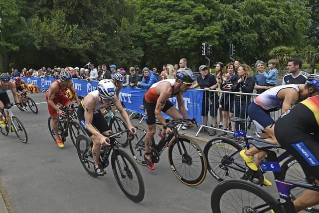 A crowd watches the mens elite triathlon on Princess Avenue outside Roundhay Park, Leeds.