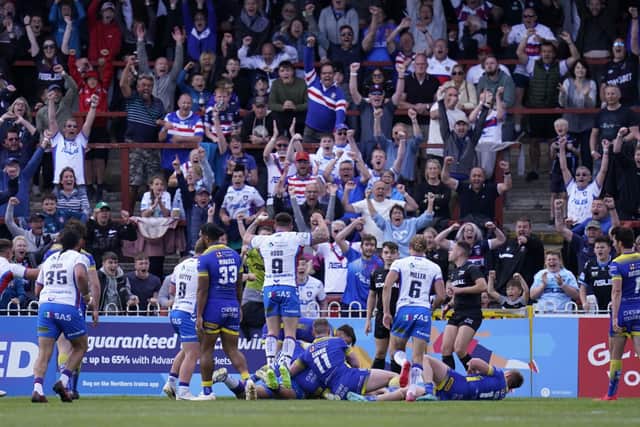 Wakefield Trinity fans celebrate in the stands as Kelepi Tanginoa scores their side's fifth try. Picture: PA