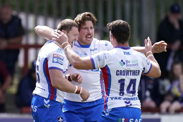 Wakefield Trinity's James Batchelor (left) celebrates with team-mates after scoring their side's first try. Picture: PA