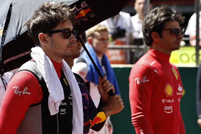 Ferrari driver Charles Leclerc of Monaco and his teammate Carlos Sainz of Spain stand prior to the start of the Azerbaijan Formula One Grand Prix at the Baku circuit. (Hamad Mohammed, Pool Via AP)
