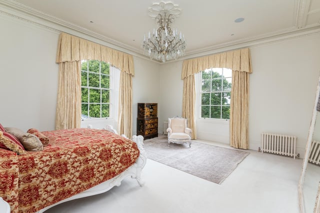 This large bedroom has dual aspect views over the grounds