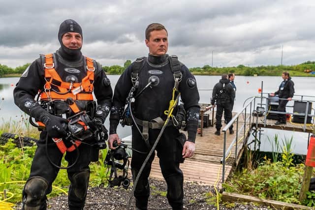 Police divers PC Roger Bennett, and PC Paul Coupland, waiting for the order to entering the water on this training exercise.