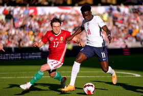 Barnsley's Callum Styles, in action for Hungary, challenges England rival Bukayo Saka on a shambolic night for the hosts at Wolverhampton. Picture: PA.