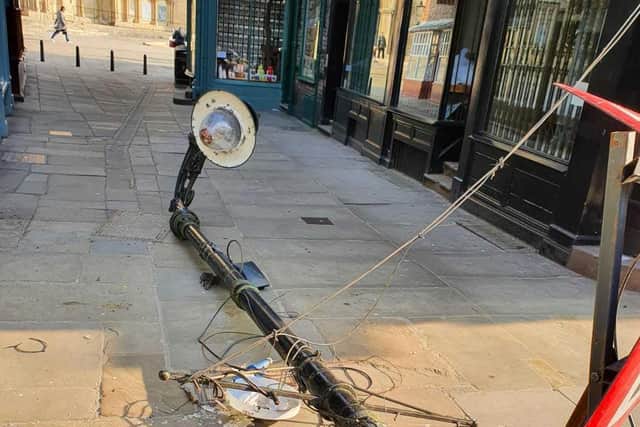 The historic lamp post on the floor after it was hit by a wagon