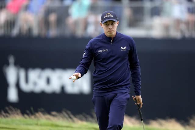Matthew Fitzpatrick, of England, reacts after putting on the 18th hole during the third round of the U.S. Open golf tournament at The Country Club. (AP Photo/Charlie Riedel)