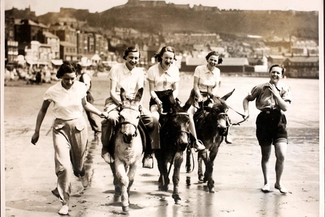 Young women riding donkeys on the beach at Scarborough, England. (Photo by Hulton Archive/Getty Images)