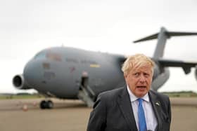Boris Johnson speaks to members of the media after arriving at RAF Brize Norton, west of London having returned from Kyiv in Ukraine, on June 18, 2022. Photo by Joe Giddens / POOL / AFP.
