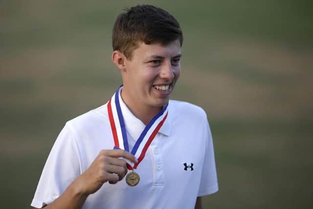 Sheffield's Matthew Fitzpatrick, England, poses with the low amateur medal after the U.S. Open golf tournament in Pinehurst, N.C., Sunday, June 15, 2014. Martin Kaymer, of Germany, won. (AP Photo/David Goldman)