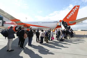 Library image of passengers prepare to board an easyJet flight to Faro, Portugal, at Gatwick Airport