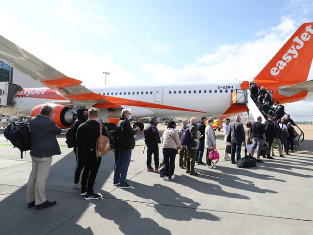 Library image of passengers prepare to board an easyJet flight to Faro, Portugal, at Gatwick Airport