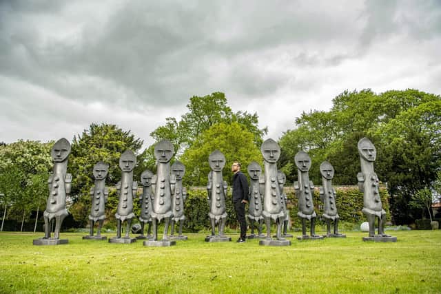 Willoughby Gerrish at Thirsk Hall looking at the Invisible Men by Zak Ové;