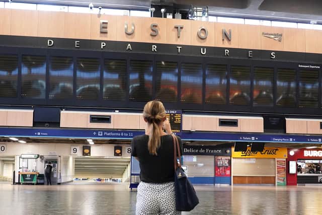 A person at a near-empty Euston station in London,