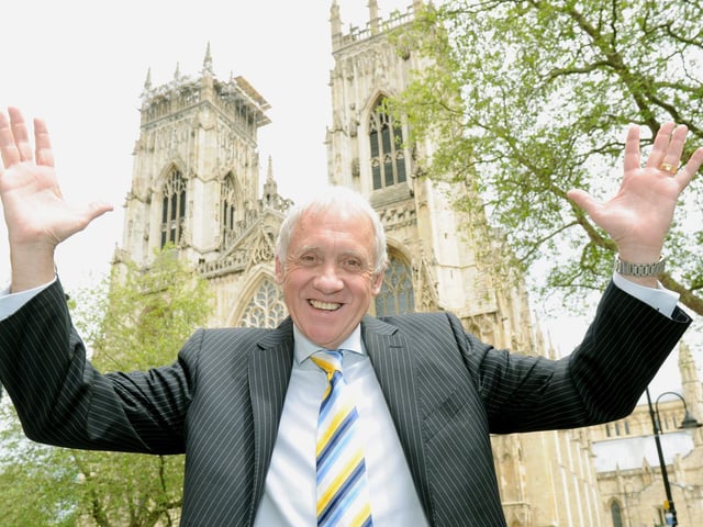 Harry Gration celebrates being awarded the MBE outside York Minster in 2013