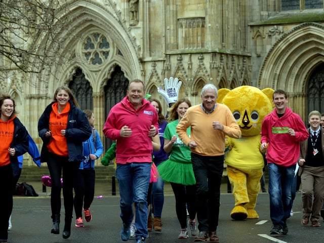 Mike Tomlinson and Harry Gration lead a group of charity fundraisers  outside York Minster at the launch of the 4th Plusnet Yorkshire Marathon in 2016