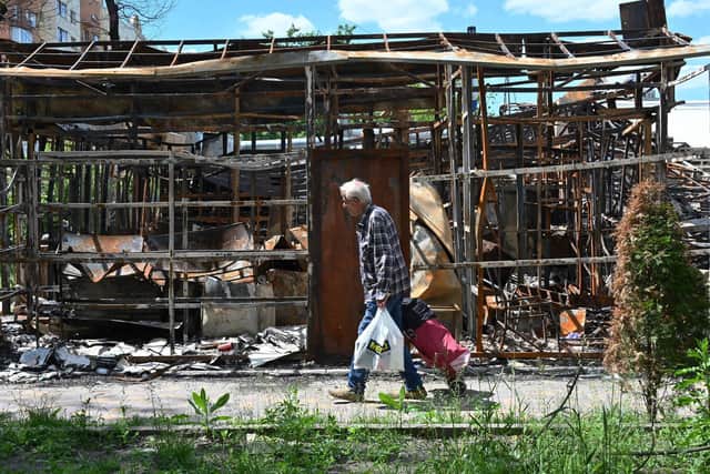A man walks past a destroyed shop in the northern outskirts of Kharkiv, amid the Russian invasion of Ukraine. Picture: SERGEY BOBOK/AFP/Getty Images