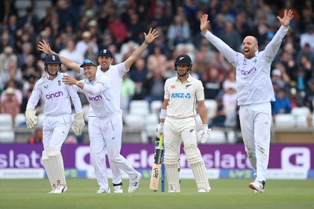 Replacement wicketkeeper Sam Billings is congratulated by team-mates after catching New Zealand batsman Neil Wagner between his legs off the bowling of Jack Leach. (Photo by Stu Forster/Getty Images)