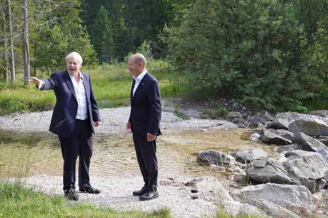 Prime Minister Boris Johnson with German Chancellor Olaf Scholz walking through the grounds during the G7 summit in Schloss Elmau, in the Bavarian Alps, Germany.
