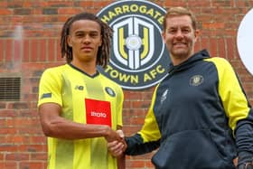 GRITTY: Miles Welch-Hayes is welcomed to Harrogate Town by manager Simon Weaver (right)