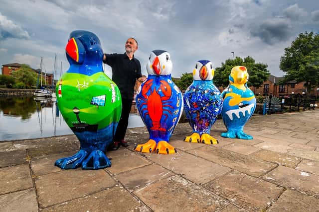 Puffins Galore! director Rick Welton with a small selection of the artworks lined up at Railway Dock Marina, Hull, ahead of today’s big reveal;