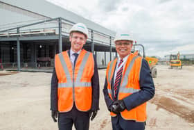 Business Minister Lee Rowley, left, and Sambit Banerjee, managing director of rolling stock and customer services for Siemens Mobility, outside the new component facility being built at Siemens Mobility’s Goole rail village.