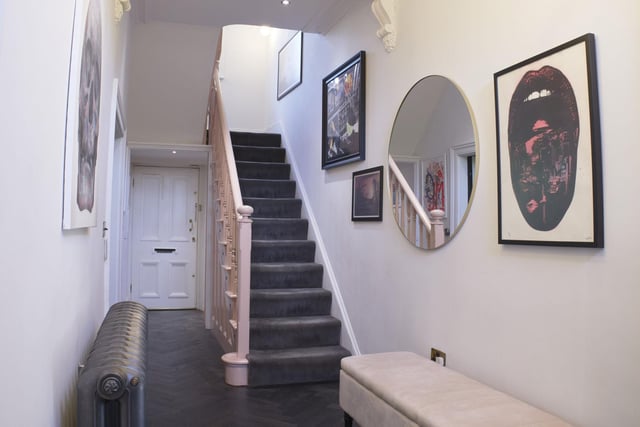 The spacious hallway is used as a gallery for the couple's art collection