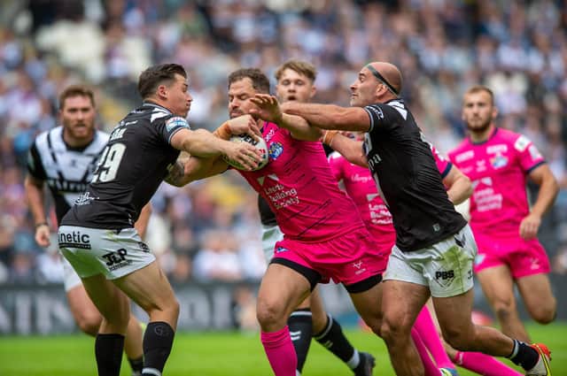 Second best: Leeds' Aidan Seizer is held by Jamie Shaul, left, and Danny Houghton. Picture: Bruce Rollinson