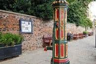 The brightly painted Gothic pump was used to supply a stone water trough until the 1940s